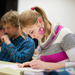 pretty, female college student sitting in a classroom
