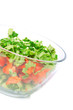 A bowl of salad with fresh lettuce, cucumber and tomato