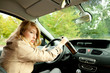 young smoking woman driving her new car