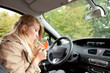 young smoking woman driving her new car