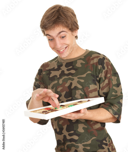 Photo: happy young man with chocolates happy young man with chocolates