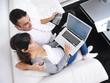 Photo: joyful couple relax and work on laptop computer at modern home joyful couple relax and work on laptop computer at modern home