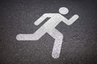 runner sign on asphalt road