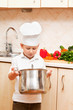 little boy on kitchen helps to make a dinner