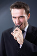 handsome businessman biting mobile phonemade  in studio