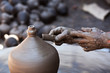 Foto: Hands of a potter, creating an earthen jar on the circle Hands of a potter, creating an earthen jar on the circle