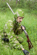 Hunter with an old rifle is considering the trail