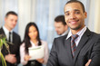 Happy african-american businessman with his team