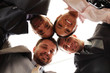 Mixed businessteam with heads together over white