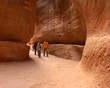 Travelers in the canyon Siq. Petra, Jordan.