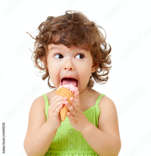 Photo: little curly girl with ice cream in studio isolated little curly girl with ice cream in studio isolated