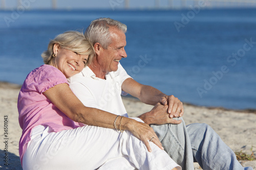 Photo: Happy Romantic Senior Couple Sitting Together on Beach Happy Romantic Senior Couple Sitting Together on Beach