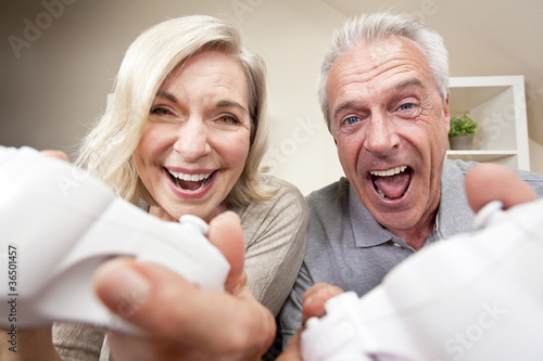 Photo: Senior Man & Woman Couple Playing Video Console Game Senior Man & Woman Couple Playing Video Console Game