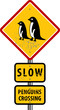Traffic warning sign with text slow, Penguin crossing