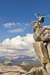 Photo: Rock climber celebrates on the summit. Rock climber celebrates on the summit.
