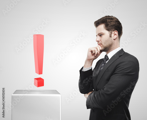 Photo: Businessman look at the red exclamation mark Businessman look at the red exclamation mark