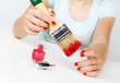 Girl paints nails with the big brush.