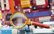 Photo: Magnifying glass and circuit board Magnifying glass and circuit board