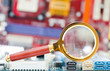 Photo: Magnifying glass and circuit board Magnifying glass and circuit board