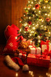 Photo: Brightly lit Christmas tree with gifts Brightly lit Christmas tree with gifts
