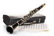 Antique clarinet, case and notebook with notes isolated on white