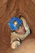 Narrow cave passage with a caver
