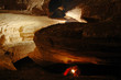 Foto: Cave passage with caver Cave passage with caver