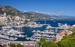 Monaco harbor with mountains and blue sky with clouds