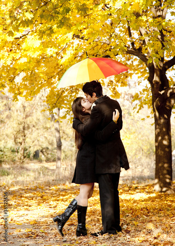 Photo: Couple kissing at alley in the park. Couple kissing at alley in the park.