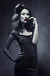 Foto: Black and white photo of seductive woman with blood on her lips Black and white photo of seductive woman with blood on her lips