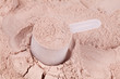 A scoop of chocolate whey isolate protein
