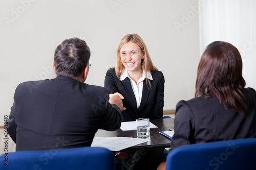 Photo: Female shaking hands at the job interview Female shaking hands at the job interview