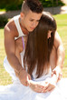 young couple happy embrace on grass, love relationship