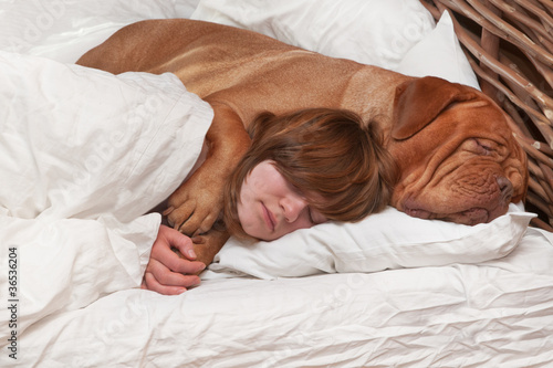 Photo: Girl and her dog in the bed Girl and her dog in the bed