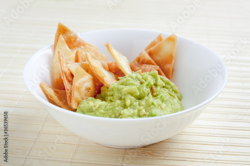 Photo: Bowl with guacamole and nachos Bowl with guacamole and nachos