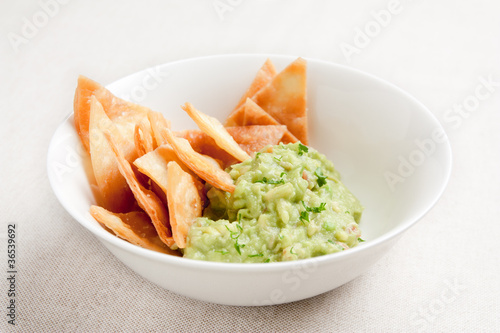 Photo: Bowl with guacamole and nachos Bowl with guacamole and nachos