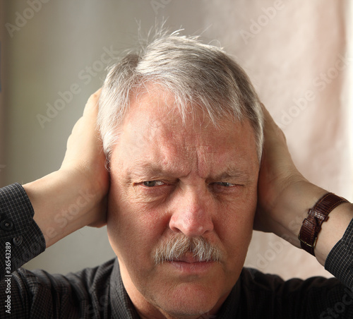 Photo: man holding hands over ears man holding hands over ears