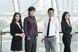 Asian Business colleagues standing in a row and smiling