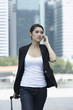 Photo: Business woman walking and using a Cell Phone Business woman walking and using a Cell Phone