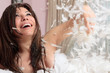 Fun woman throwing handful of feather and down
