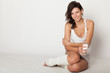 young woman  sitting on floor