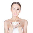 Young beautiful brunette woman holding flower in her hands over