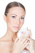 Young beautiful brunette woman holding flower in her hands over
