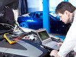 Motor mechanic is tuning and checking the engine of a car