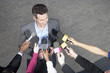 Reporters holding microphones for politician