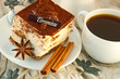 Cake tiramisu and a cup of hot coffee
