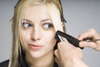 Hairdresser cutting hair with comb