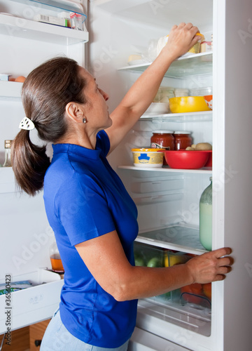 Photo: woman taking something of the fridge woman taking something of the fridge