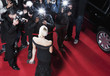 Celebrity posing for paparazzi on red carpet