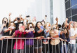 Fans taking pictures with cell phones behind barrier Fans taking pictures with cell phones behind barrier